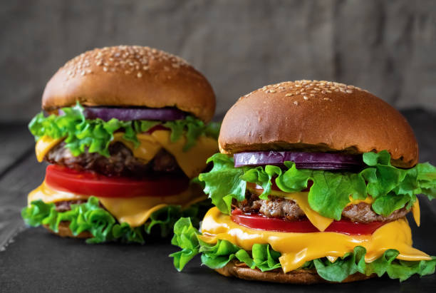 istock Two fresh hamburger on dark stone table. closeup. Shallow depth of field. 1210334029