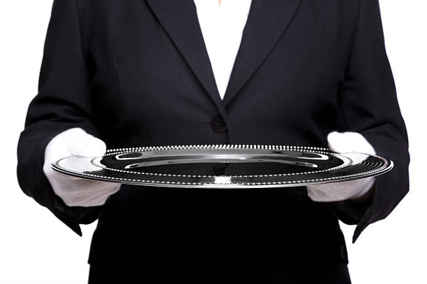 mujer sosteniendo una bandeja de mayordomo plata aislado en blanco. - serving tray silver plate fotografías e imágenes de stock