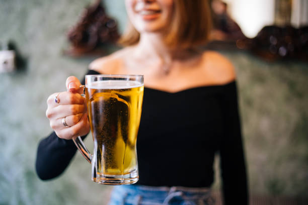 istock Beautiful woman drinking beer and dancing 1210336610