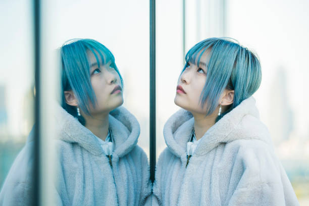 istock young woman and her reflection 1210336811
