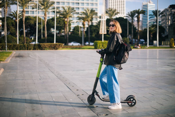 istock Joyful woman riding a motor scooter 1210336816