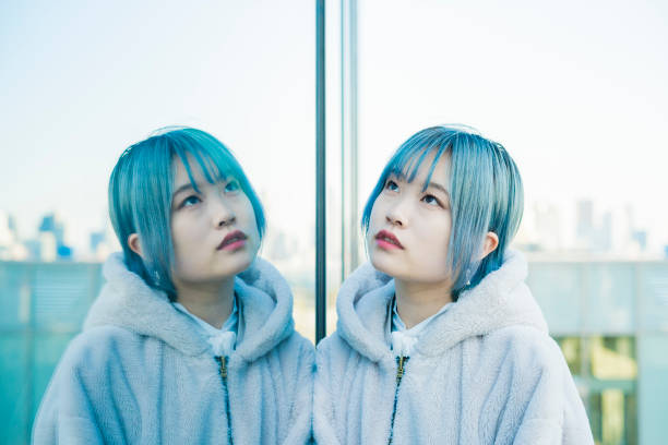 istock young woman and her reflection 1210336890