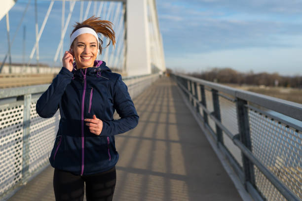 istock Young woman running on the bridge 1210336942