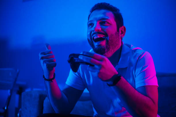 istock Happy man celebrating victory in video game 1210337212