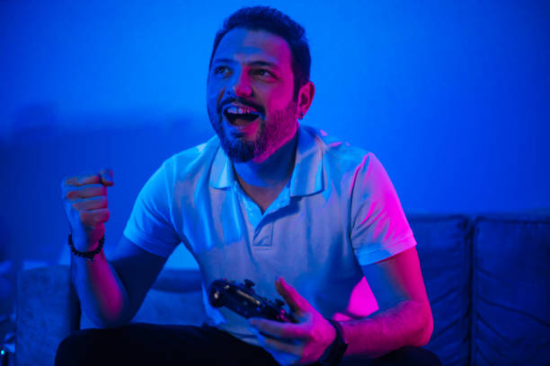 istock Happy man celebrating victory in video game 1210338026