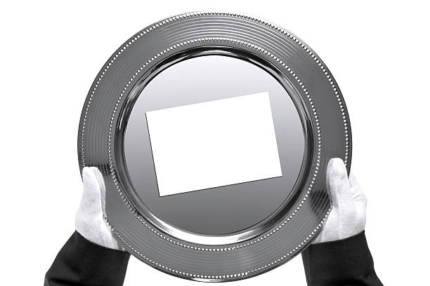 Butler holding a silver tray, shot from above