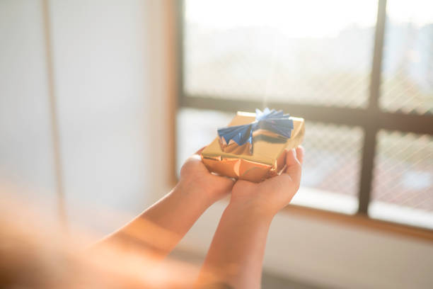 istock woman with a gift stock 1210340257