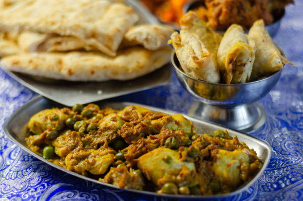 istock Chicken jalfrezi and chicken curry with various rice and onion Bhajis and Samosas 1210340327