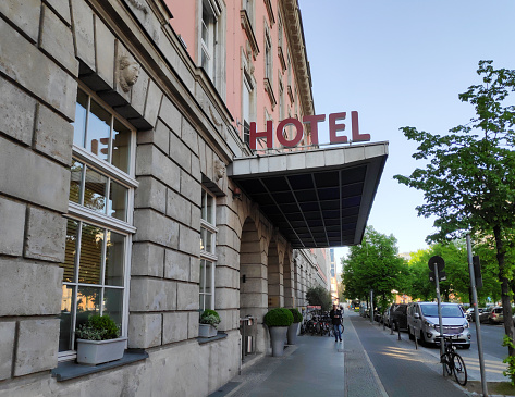 Berlin, Germany - April 29, 2019: A man checks his phone outside a hotel in Berlin Germanyz