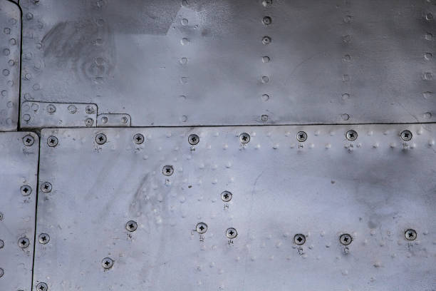 istock Aircraft skin close up. Rivets on gray metal. 1210342996
