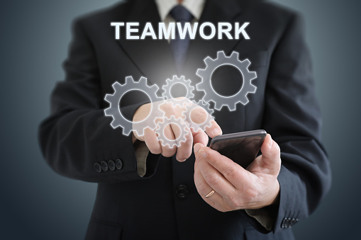Teamwork cogwheel cooperation businessman togetherness partnership