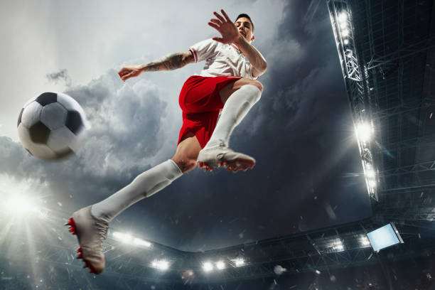 istock Football or soccer player at stadium - motion, action, activity concept 1210344328
