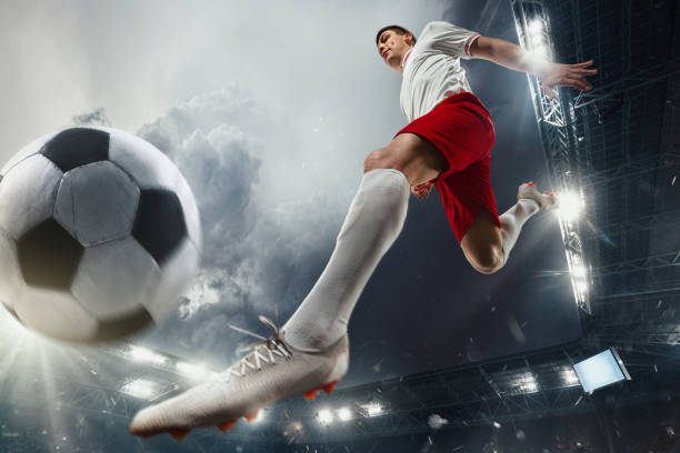istock Football or soccer player at stadium - motion, action, activity concept 1210344334