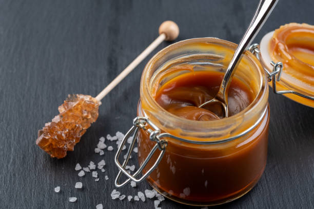 istock Homemade salted caramel sauce. Selective focus, space for text. On dark background 1210344536