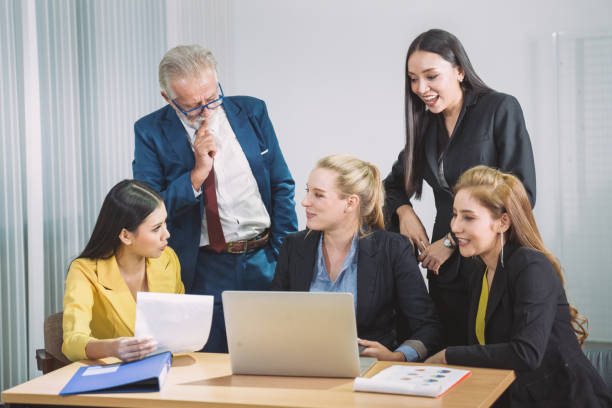 istock Multi-ethnic team discussion using laptop and digital tablet for online marketing analyzing, business strategic planning, online video conferencing and leadership training. 1210344823