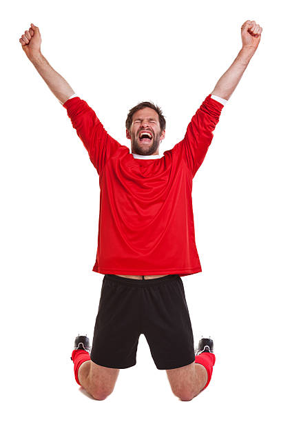 istock Footballer dressed in red and black on white background 121034540