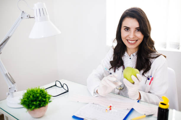 istock Female Doctor Injecting Apple 1210345730