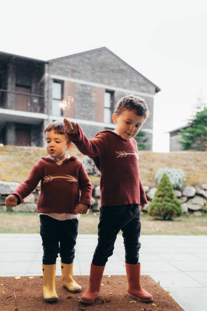 istock Boys holding sparklers for New Year's Eve 1210347219