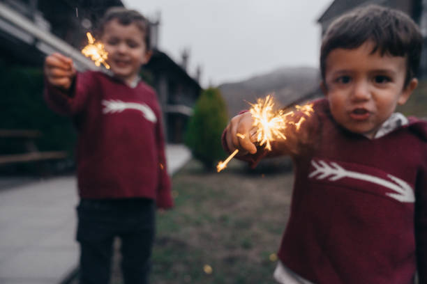 istock Boys holding sparklers for New Year's Eve 1210347649