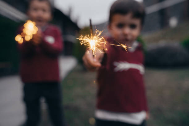 istock Boys holding sparklers for New Year's Eve 1210347787