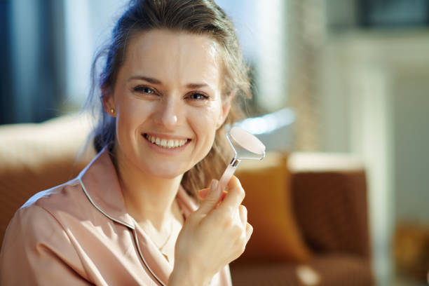 istock happy stylish female using calming quartz roller massager 1210347798