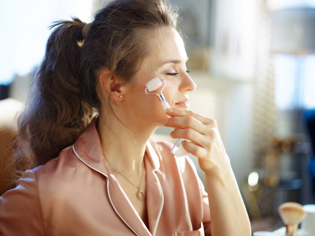 istock relaxed young woman using calming quartz roller massager 1210347852