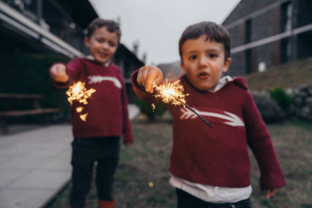 istock Boys holding sparklers for New Year's Eve 1210347910
