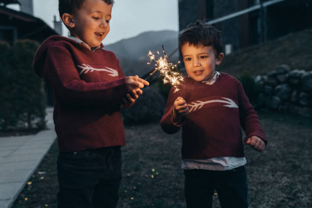 istock Boys holding sparklers for New Year's Eve 1210348086