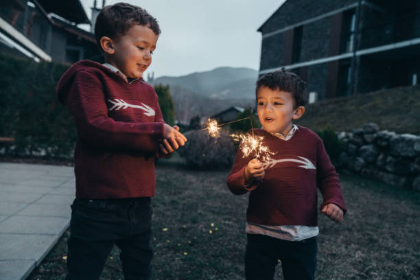 istock Boys holding sparklers for New Year's Eve 1210348253