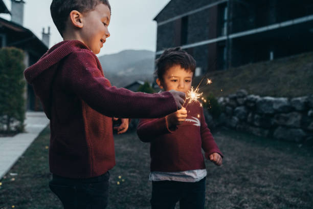 istock Boys holding sparklers for New Year's Eve 1210348791