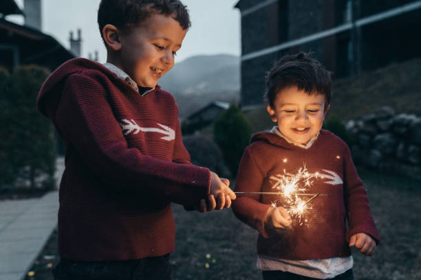 istock Boys holding sparklers for New Year's Eve 1210349396