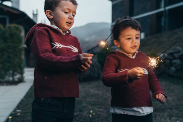 istock Boys holding sparklers for New Year's Eve 1210349466