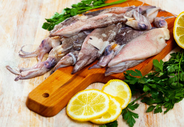 istock Raw calamari on wooden table 1210349557
