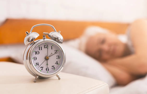 istock Senior woman sleeping in bed on blurred background 1210349894