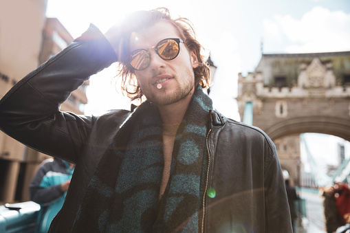 Young fashionable man walking on Tower Bridge in London