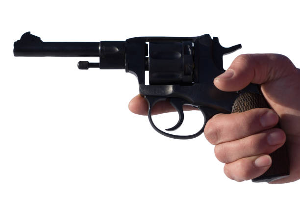 A hand holding a semi automatic handgun that is in ready position to shoot, studio shot