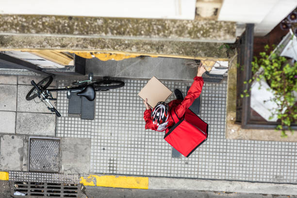 istock Pizza delivery person ringing on customer's intercom 1210351169