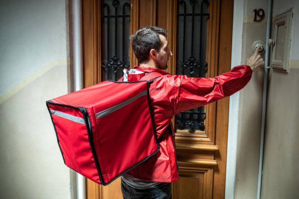 istock Delivery person ringing on customer's doorbell 1210351179
