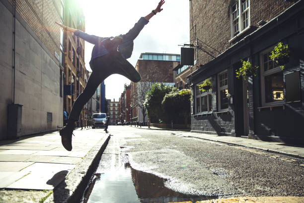 Man jumping a puddle after the storm