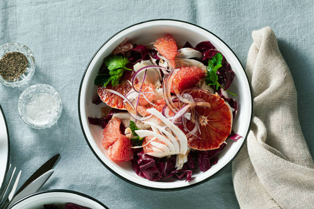 istock Sicilian salad with fennel, oranges, grapefruit and radicchio salad with balsamic dressing on a blue linen tablecloth. healthy summer italian food 1210351721