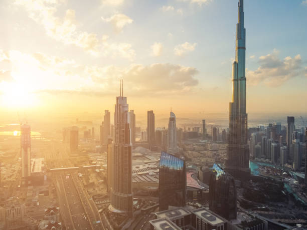 Drone Point View of Dubai Skyline at Sunrise View of Dubai Skyline with Burj Khalifa and Road Intersection at Sunrise burj khalifa photos stock pictures, royalty-free photos & images