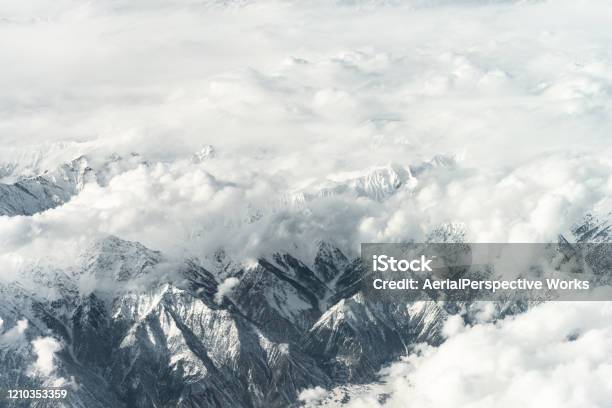Aerial View Of Snow Capped Mountains Against Sky Stock Photo - Download Image Now - Mountain, K2 - Mountain, Winter