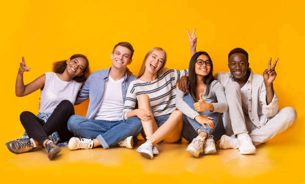 istock Carefree teenagers having fun over yellow studio background 1210353367