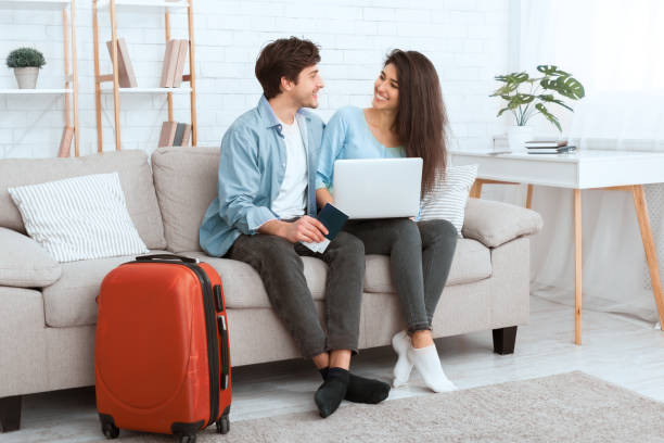 istock Booking tour. Happy couple using laptop, preparing for travel 1210353693