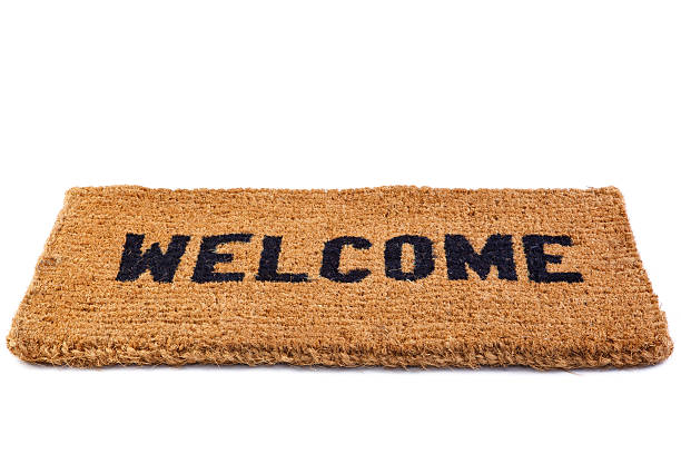 Welcome mat cut out Photo of a welcome door mat isolated on a white background. hello single word photos stock pictures, royalty-free photos & images