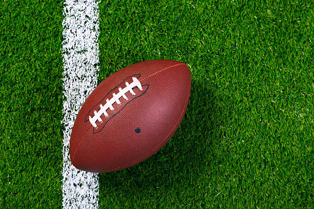 American football on grass from above. stock photo