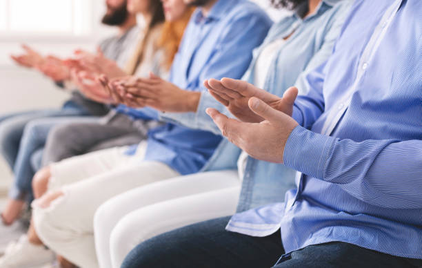 istock Therapy Session Members Sitting In A Row And Applauding To Speaker 1210354919