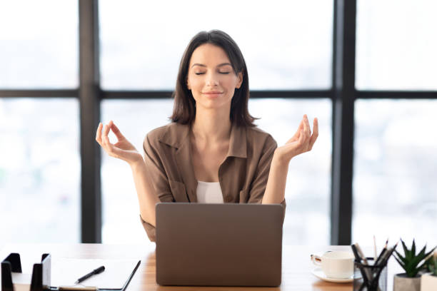 istock Girl meditating in office coping with stress at work 1210355808