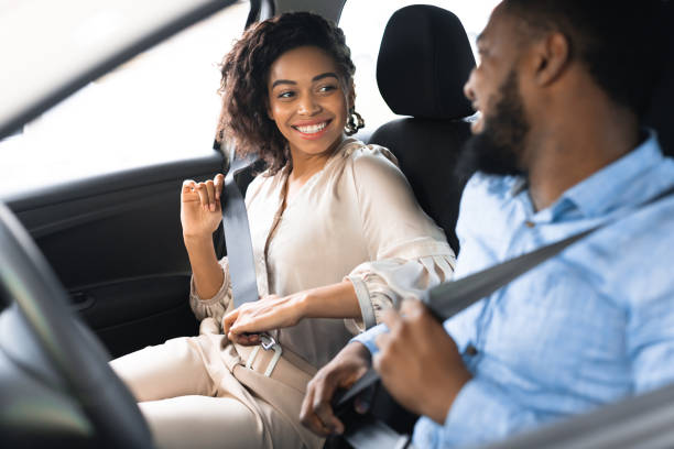 istock Joyful Spouses Putting On Seat Belts Sitting In New Automobile 1210356013