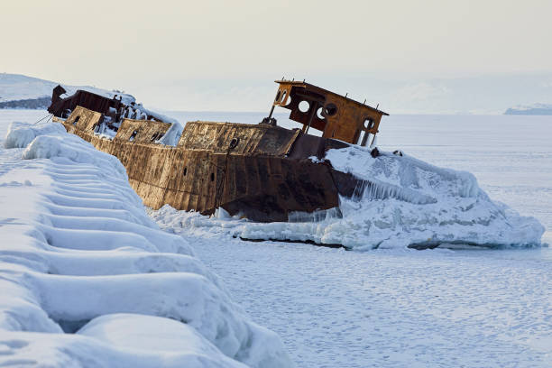 istock An old sunken ship at the pier covered in ice 1210358870